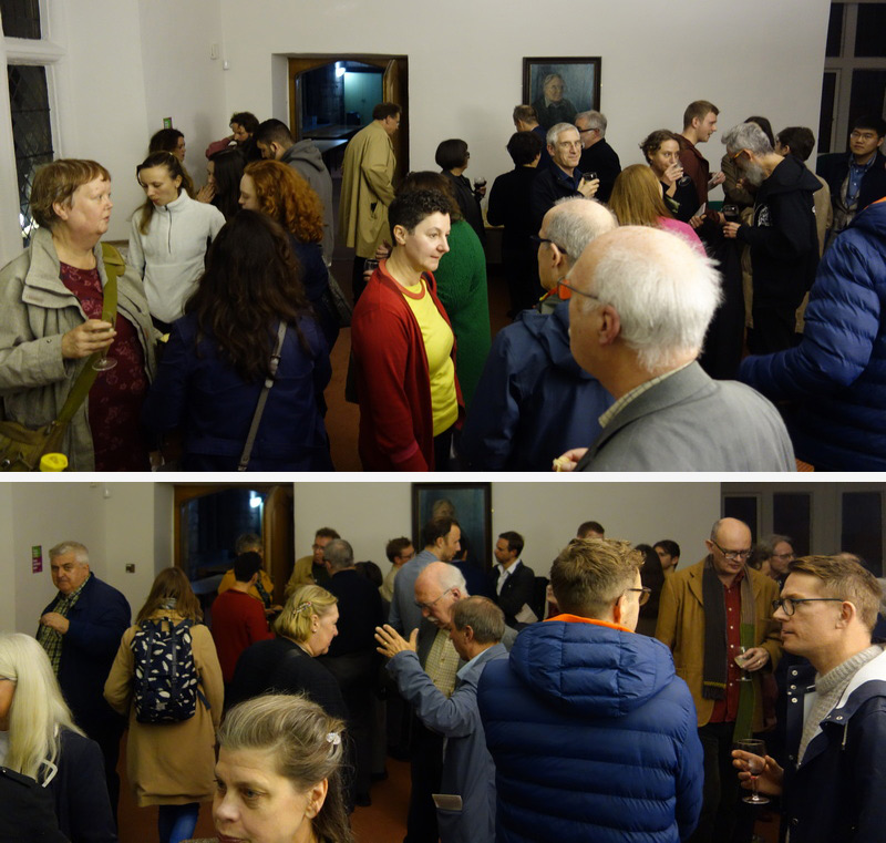 Lots of people gathered together for an informal wine reception