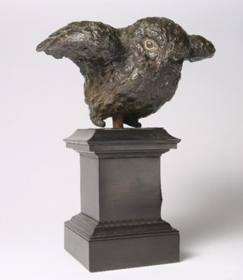 Bronze sculpture of a small owl with opening wings